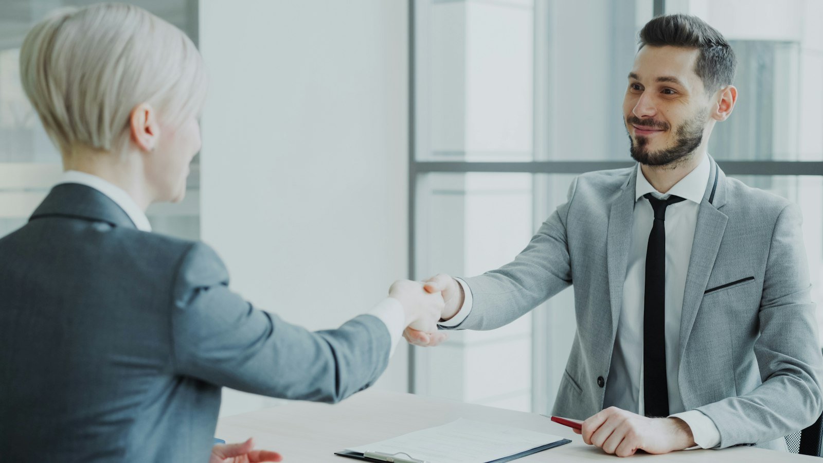 Two professionals shaking hands at a meeting
